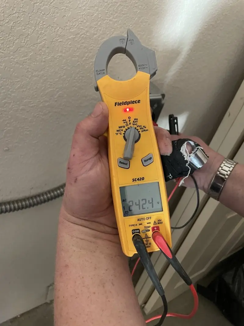 Voltage testing with clamp meter during Recessed Lighting Installation in Chandler